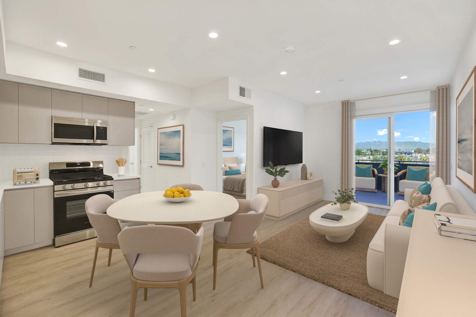 Staged kitchen and dining with quartz counters and stainless appliances